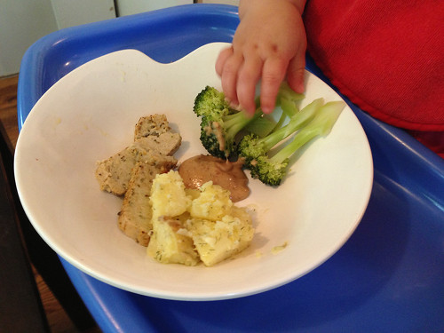 A young baby's dinner, organic tofu, lemon dill potato salad, steamed broccoli, and almond dipping sauce